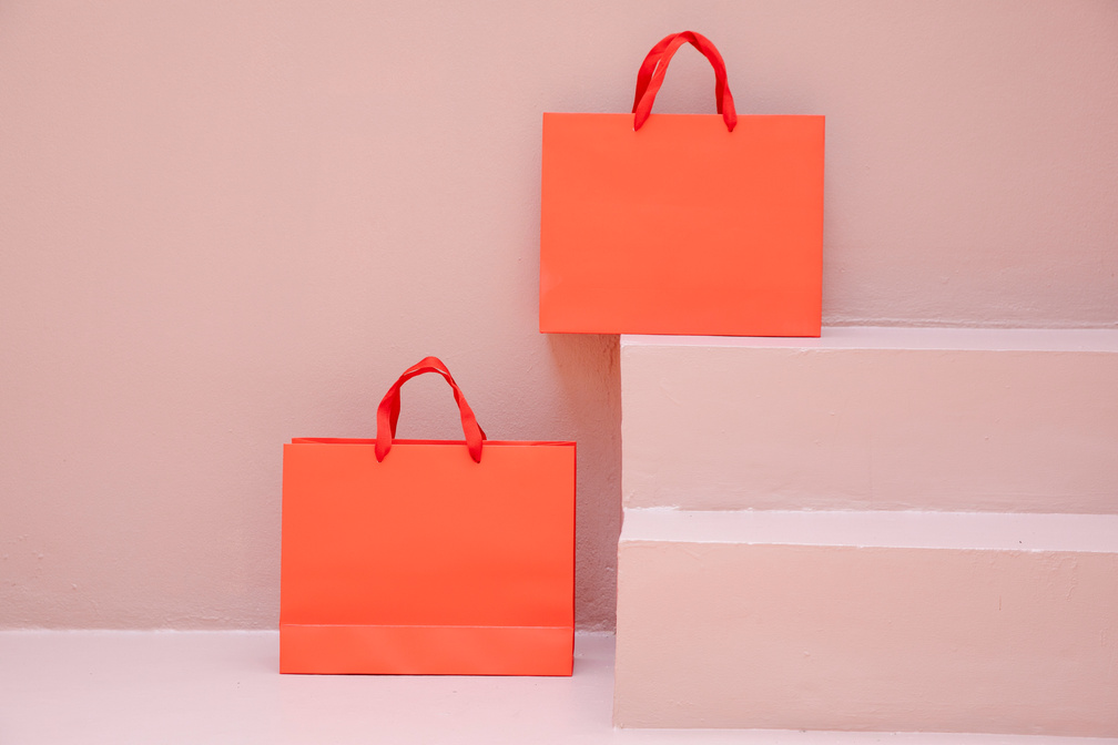 Orange Shopping Bags over Pink Surface
